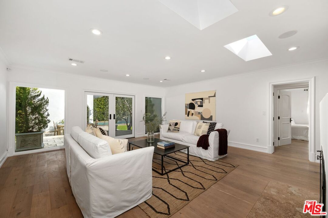 514 Walden Drive Beverly Hills, CA 90210 - Photo 28 of 59 a living room with furniture and a window