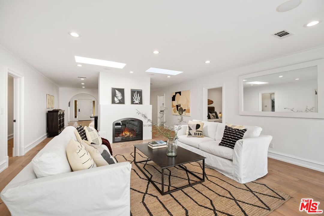514 Walden Drive Beverly Hills, CA 90210 - Photo 30 of 59 a living room with fireplace furniture and a view of kitchen