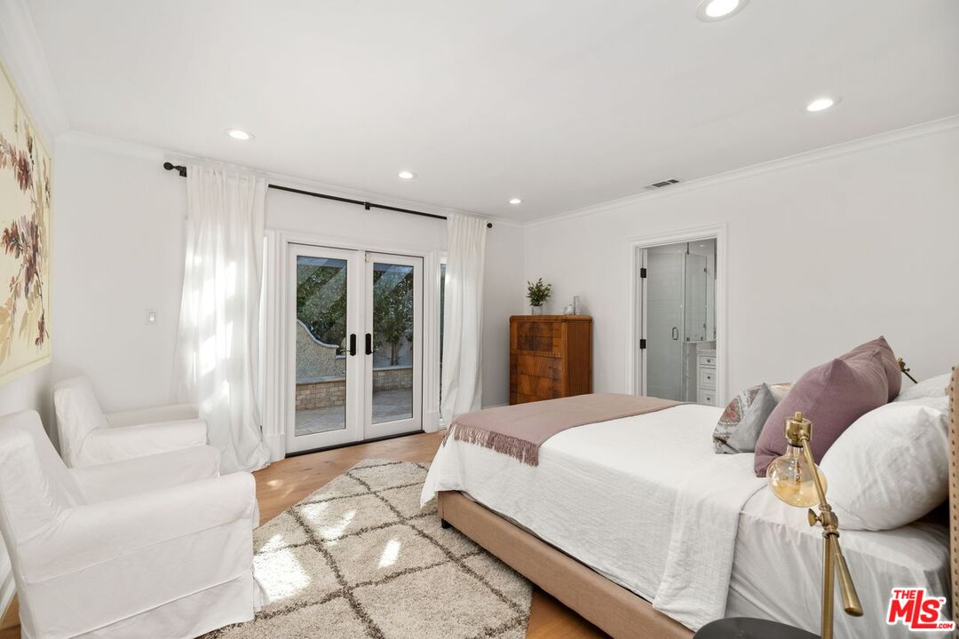 514 Walden Drive Beverly Hills, CA 90210 - Photo 34 of 59 a bedroom with a large bed and a couch