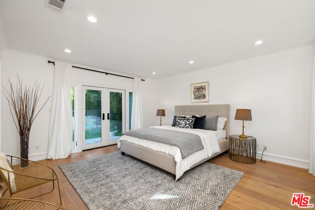 514 Walden Drive Beverly Hills, CA 90210 - Photo 37 of 59 a spacious bedroom with a large bed and a couch
