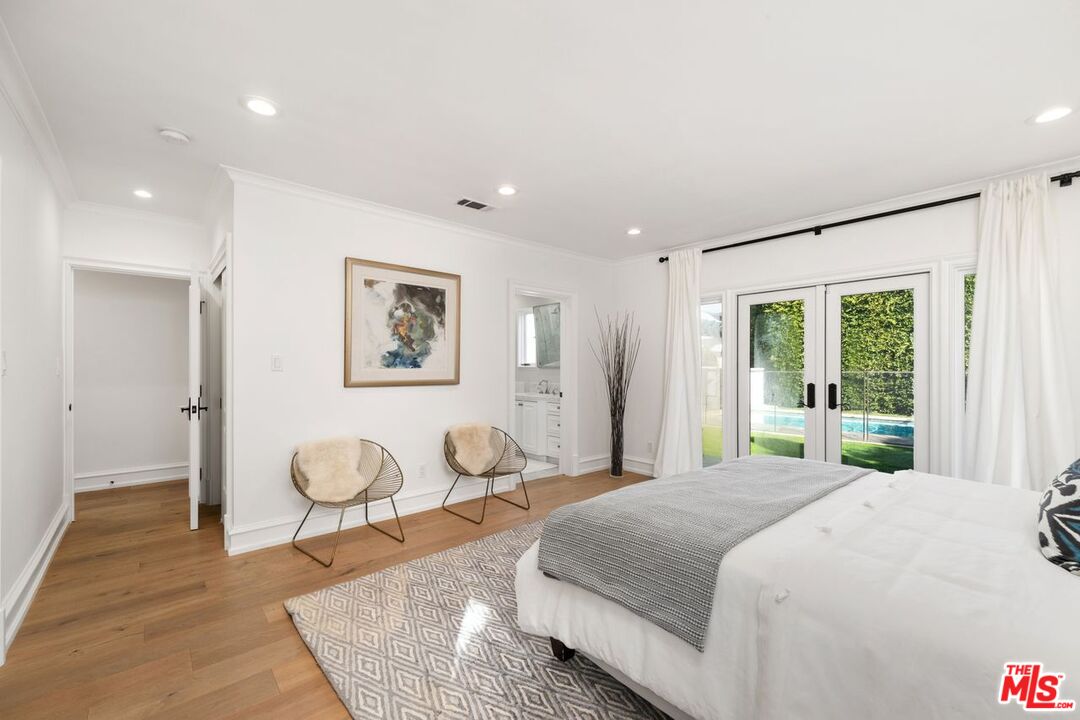 514 Walden Drive Beverly Hills, CA 90210 - Photo 38 of 59 a spacious bedroom with a bed and a large window