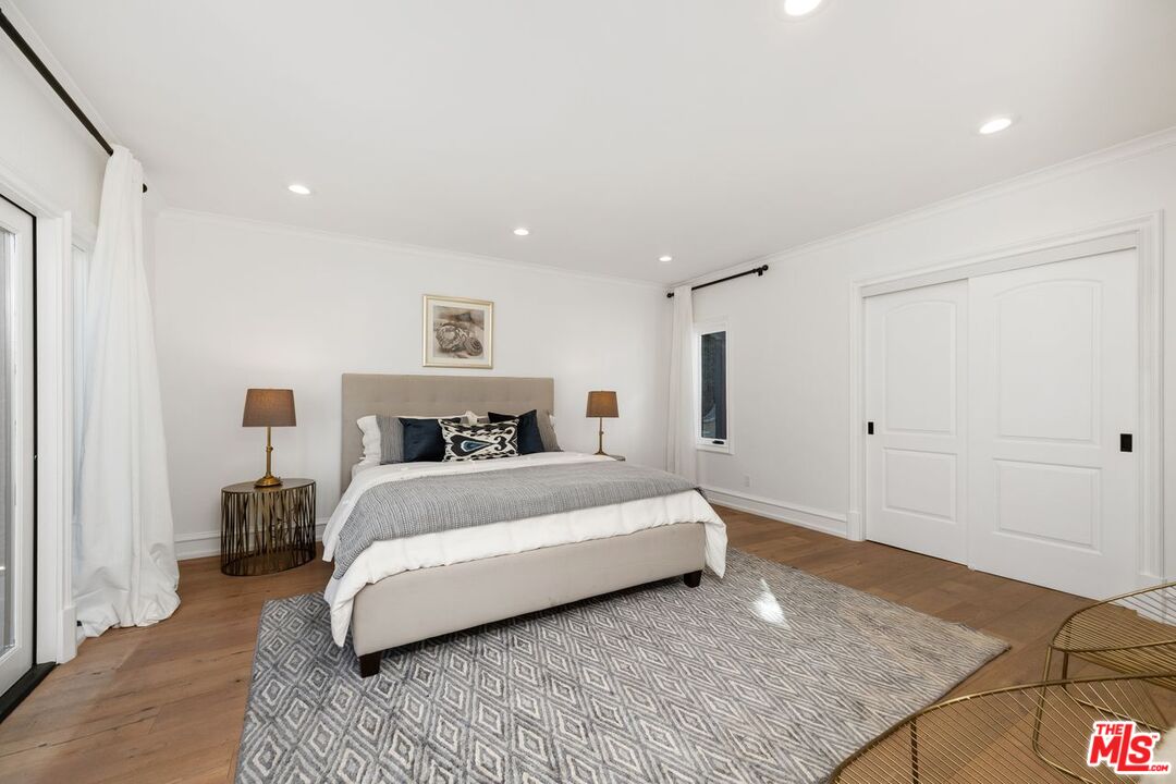514 Walden Drive Beverly Hills, CA 90210 - Photo 39 of 59 a spacious bedroom with a bed and a couch