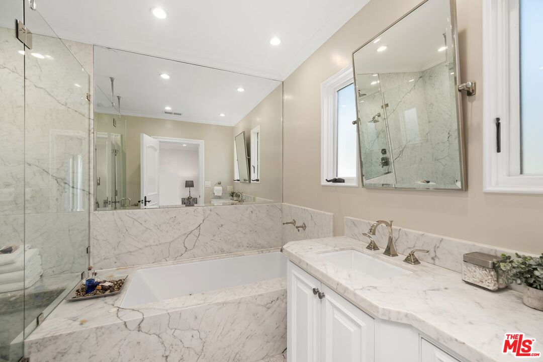 514 Walden Drive Beverly Hills, CA 90210 - Photo 41 of 59 a bathroom with a tub sink and mirror