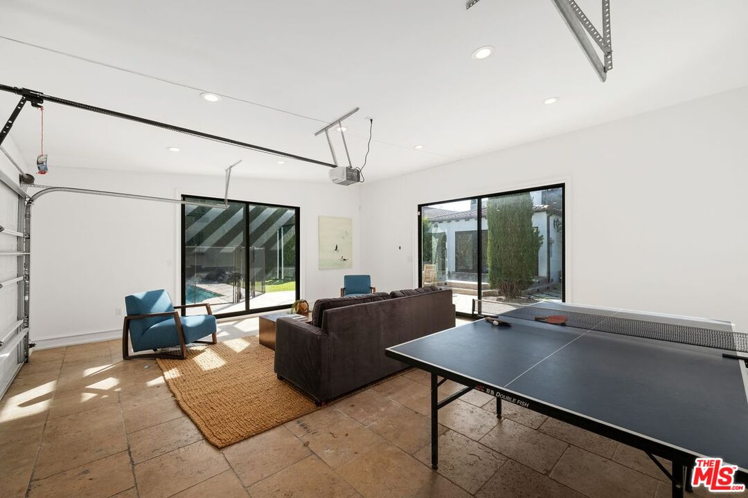 514 Walden Drive Beverly Hills, CA 90210 - Photo 43 of 59 a living room with furniture large window and flat screen tv