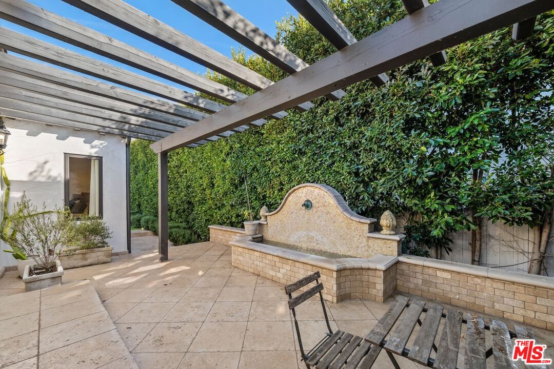 514 Walden Drive Beverly Hills, CA 90210 - Photo 44 of 59 a front view of a house with garden