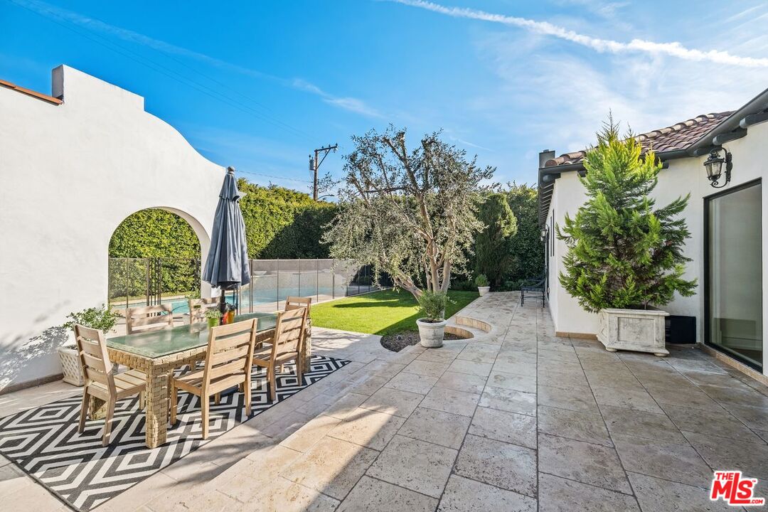 514 Walden Drive Beverly Hills, CA 90210 - Photo 49 of 59 a view of a swimming pool with a lounge chairs