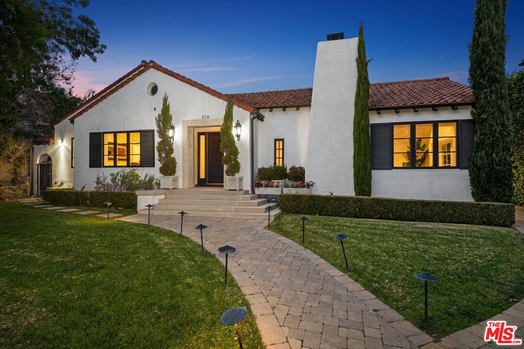 514 Walden Drive Beverly Hills, CA 90210 - Photo 54 of 59 a front view of a house with a yard
