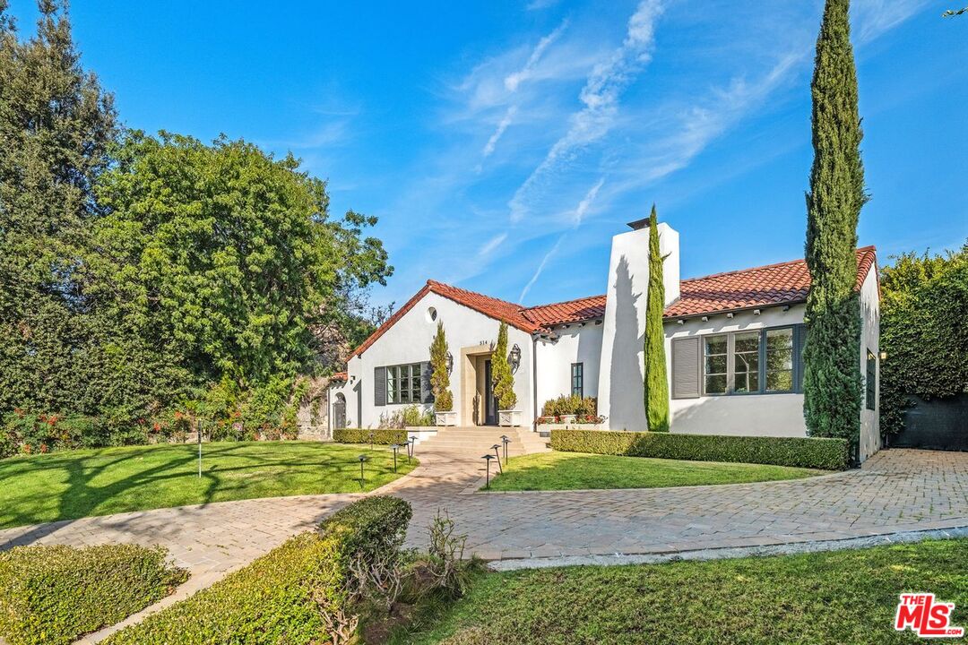 514 Walden Drive Beverly Hills, CA 90210 - Photo 7 of 59 a front view of a house with a yard