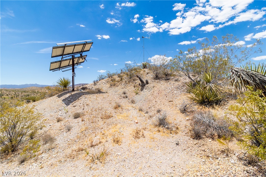 Rocking S Ranch Road Searchlight, NV 89046 - Photo 35 of 47 Solar panels nestled in a rugged landscape provide sustainable energy.