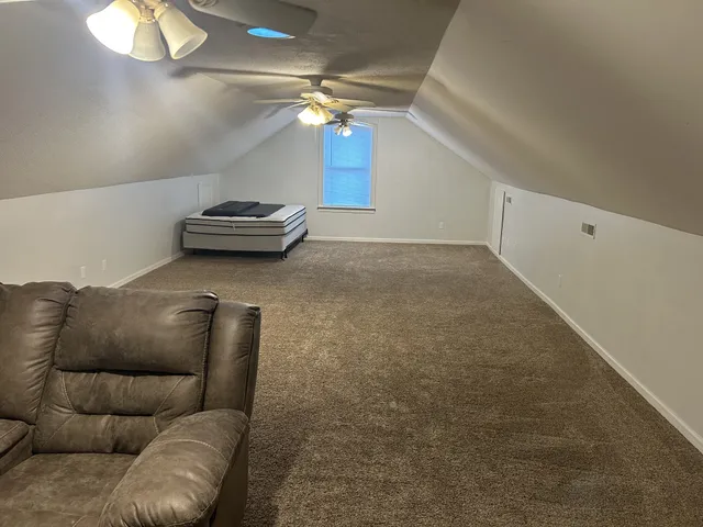 a living room with furniture and a view of entryway