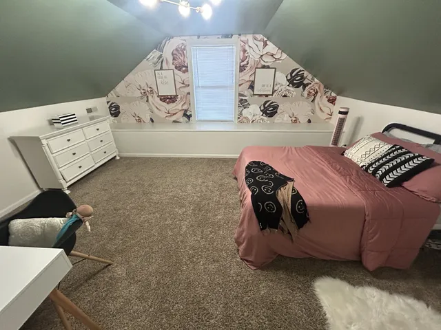a bedroom with a bed and window