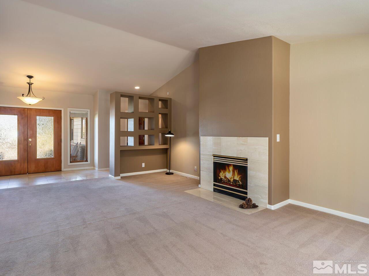 7210 Cheltenham Way Reno, NV 89502 - Photo 11 of 26 an empty room with furniture and fireplace