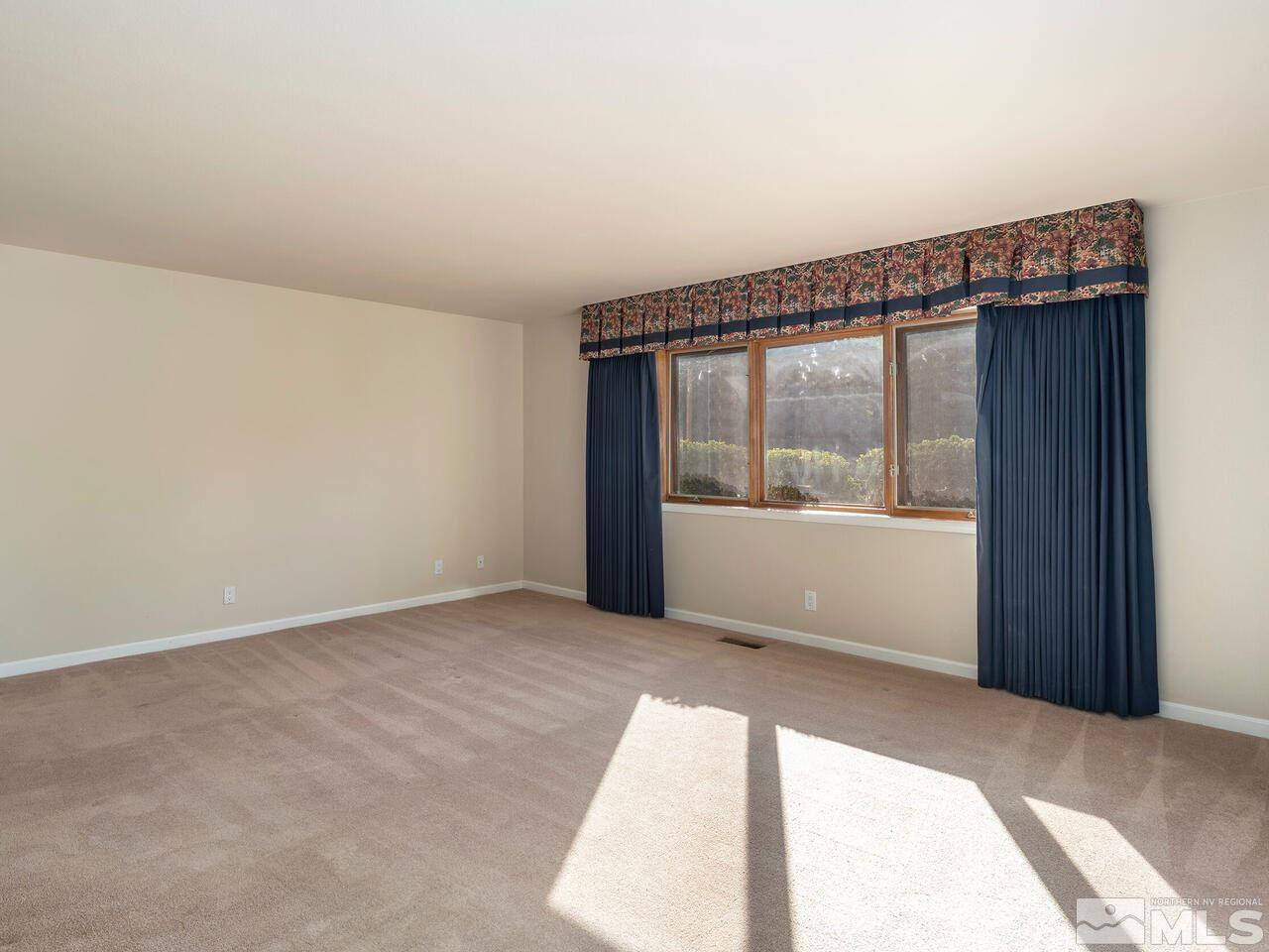 7210 Cheltenham Way Reno, NV 89502 - Photo 17 of 26 a view of an empty room with a window