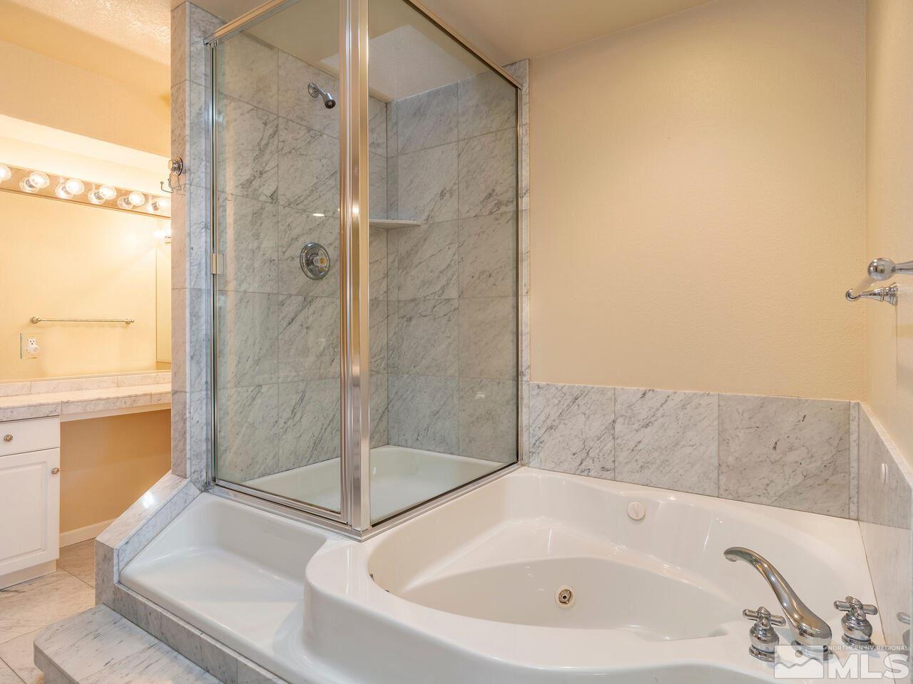 7210 Cheltenham Way Reno, NV 89502 - Photo 19 of 26 a bathroom with a bathtub and a shower
