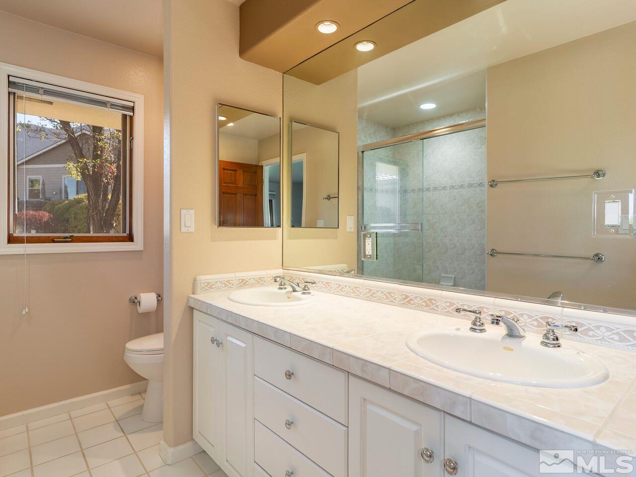 7210 Cheltenham Way Reno, NV 89502 - Photo 20 of 26 a bathroom with a double vanity sink mirror and toilet