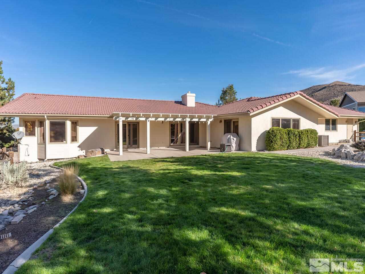 7210 Cheltenham Way Reno, NV 89502 - Photo 23 of 26 a front view of a house with a garden
