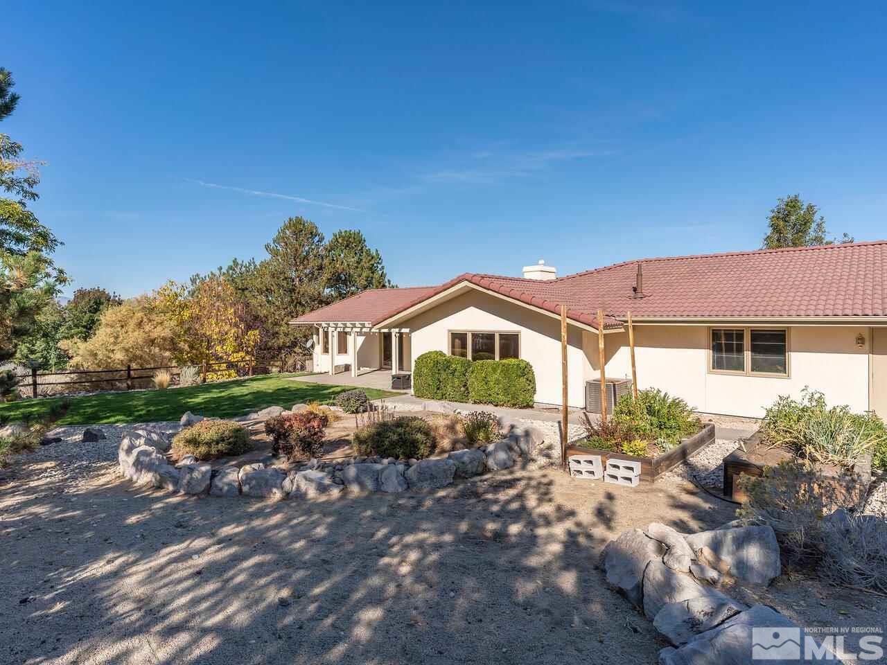7210 Cheltenham Way Reno, NV 89502 - Photo 24 of 26 a front view of a house with a yard