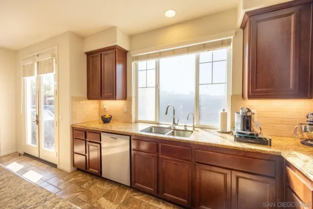a bathroom with a sink toilet and window