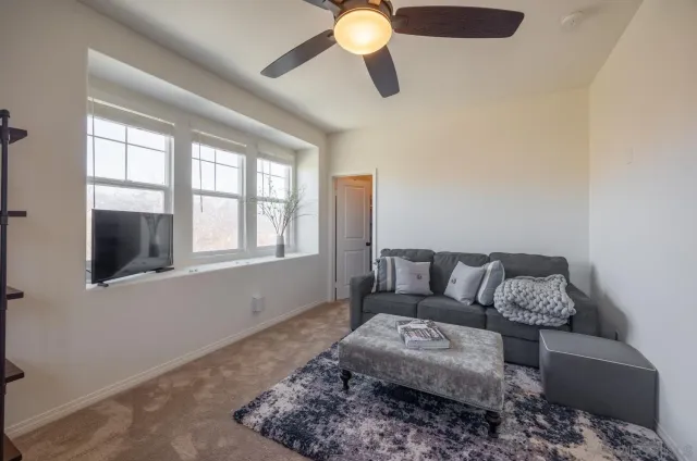 a view of a house with backyard and sitting area