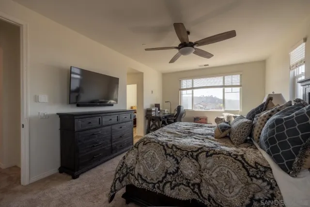 a backyard of a house with fountain plants and wooden fence