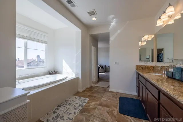 a view of a park with potted plants and large trees