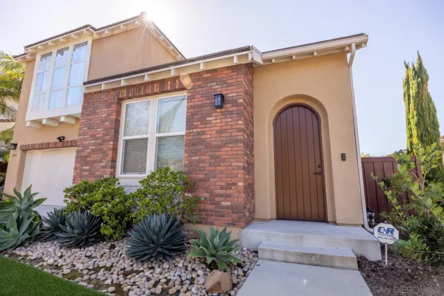 a front view of a house with garden