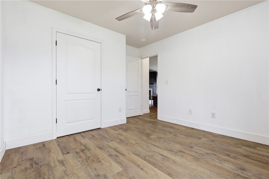 105 Lacy Lane Anderson, SC 29621 - Photo 11 of 16 A well-lit room with wood flooring, ceiling fan, and crisp white trim.