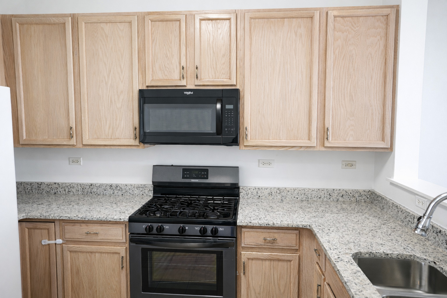 2441 Oneida Lane, Unit 2441 Naperville, IL 60563 - Photo 5 of 21 a kitchen with granite countertop white cabinets and stainless steel appliances