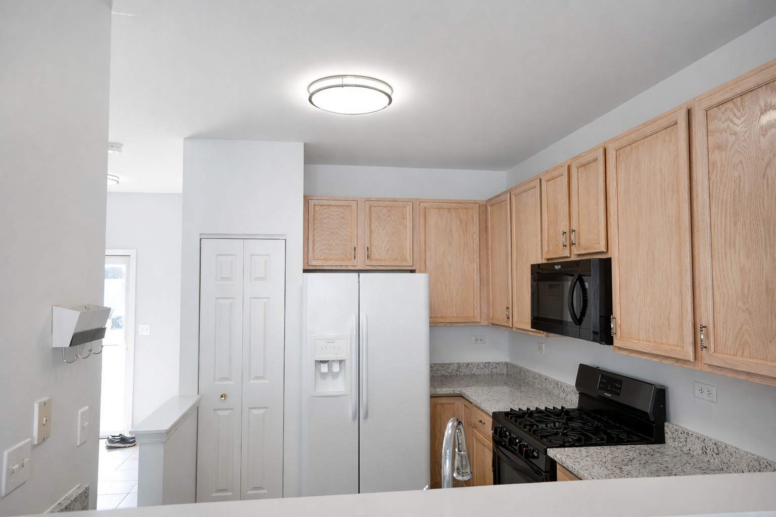 2441 Oneida Lane, Unit 2441 Naperville, IL 60563 - Photo 6 of 21 a kitchen with cabinets and stainless steel appliances