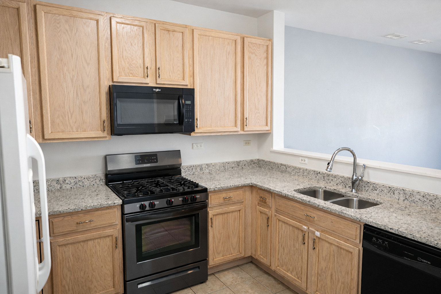2441 Oneida Lane, Unit 2441 Naperville, IL 60563 - Photo 8 of 21 a kitchen with granite countertop white cabinets and appliances