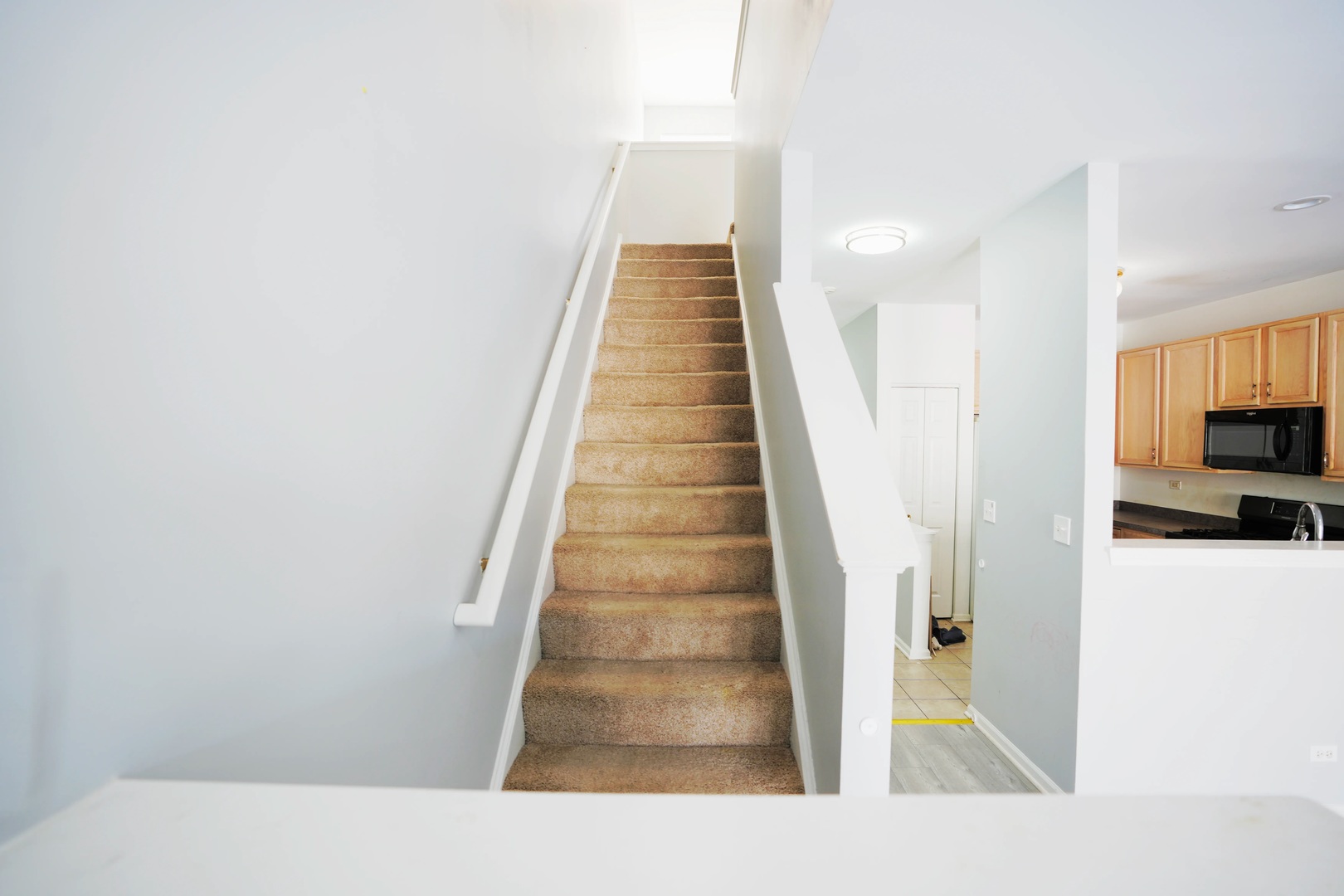 2441 Oneida Lane, Unit 2441 Naperville, IL 60563 - Photo 9 of 21 a view of a hallway with wooden floor and staircase