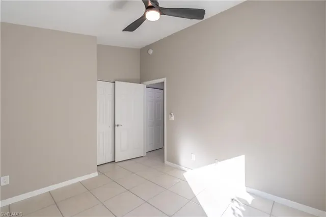 a view of an empty room and window and wooden floor