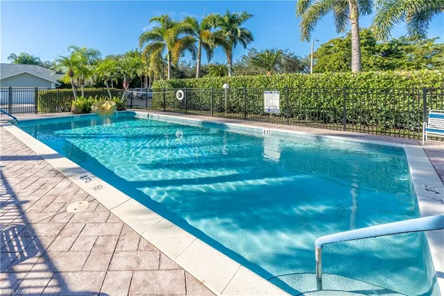 a view of a swimming pool with a table and chairs
