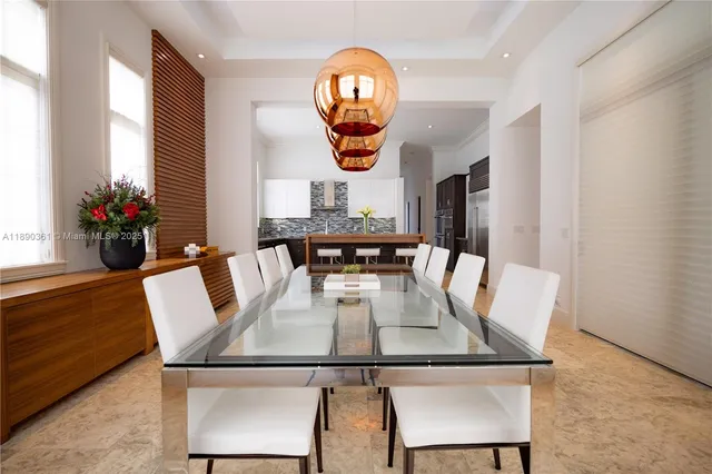a view of kitchen with kitchen island granite countertop a sink and a counter top space