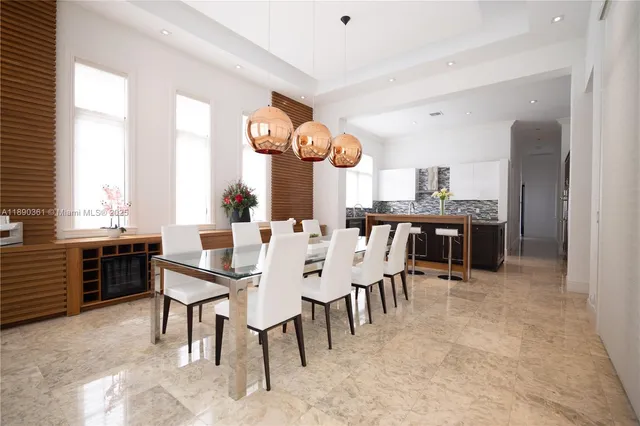 a kitchen with kitchen island granite countertop a sink and a stove