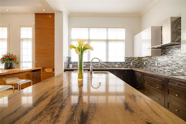 a kitchen with stainless steel appliances granite countertop a refrigerator and a stove