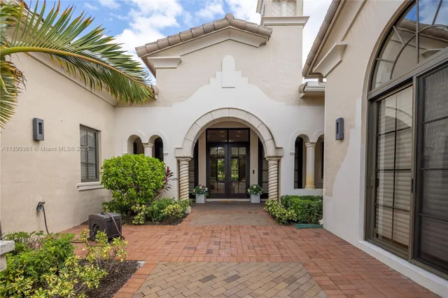 a living room with furniture and floor to ceiling windows