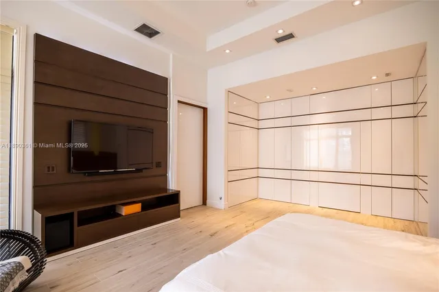 a white toilet sitting next to a bath tub and a shower