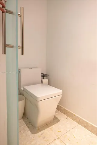 a view of a white house with a large pool and a large tree