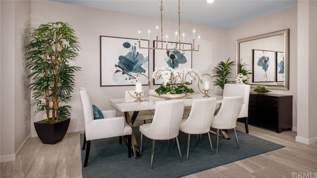 a view of a dining room with furniture and chandelier