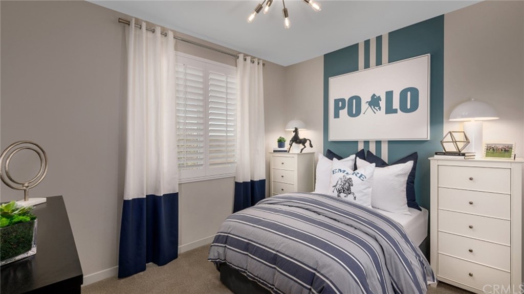 39614 Taffala Drive Indio, CA 92203 - Photo 9 of 14 a bedroom with a bed and a chandelier