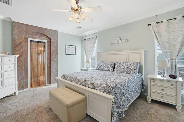 a bedroom with a bed and a flat screen tv in it