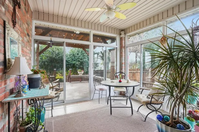 a building outdoor space with patio furniture and potted plants