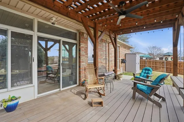 a view of a patio with a dining table and chairs