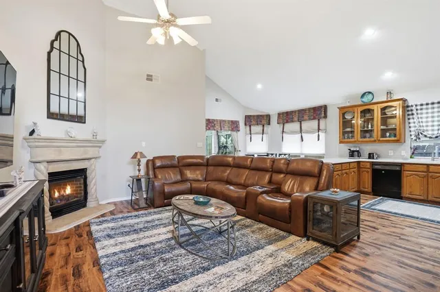 a living room with furniture a flat screen tv and a fireplace