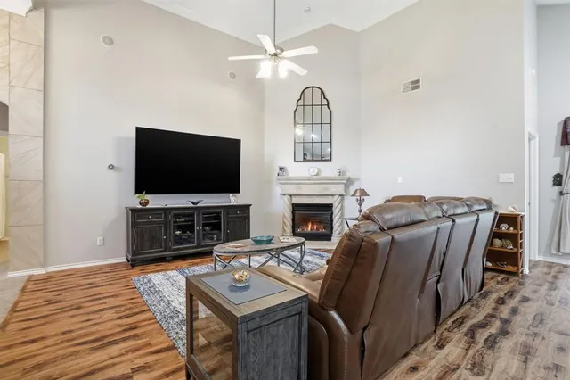 a kitchen that has a kitchen island wooden cabinets and a refrigerator