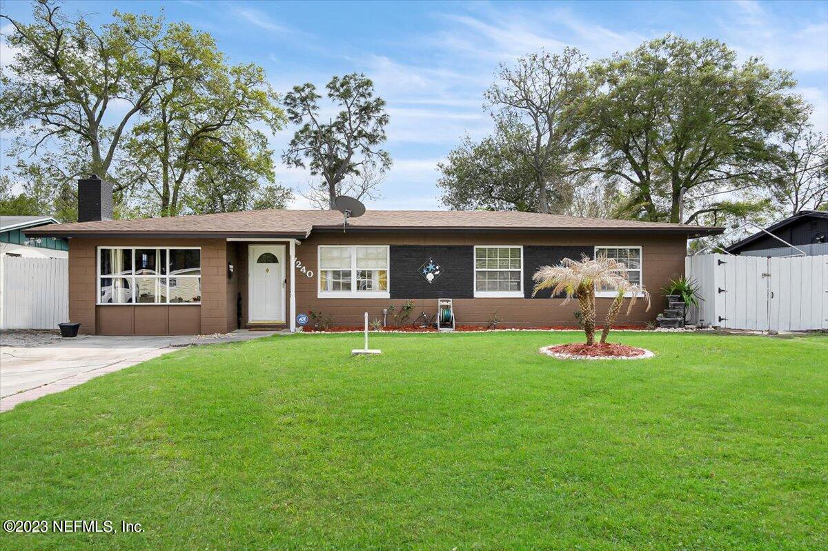 a front view of a house with a yard and porch