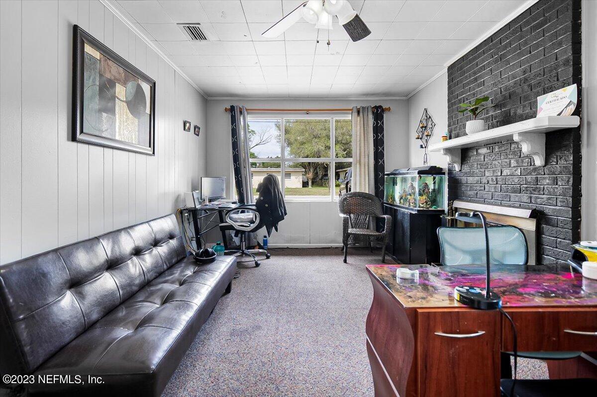 7240 Adele Court Jacksonville, FL 32277 - Photo 12 of 27 a living room with furniture oven and a fireplace