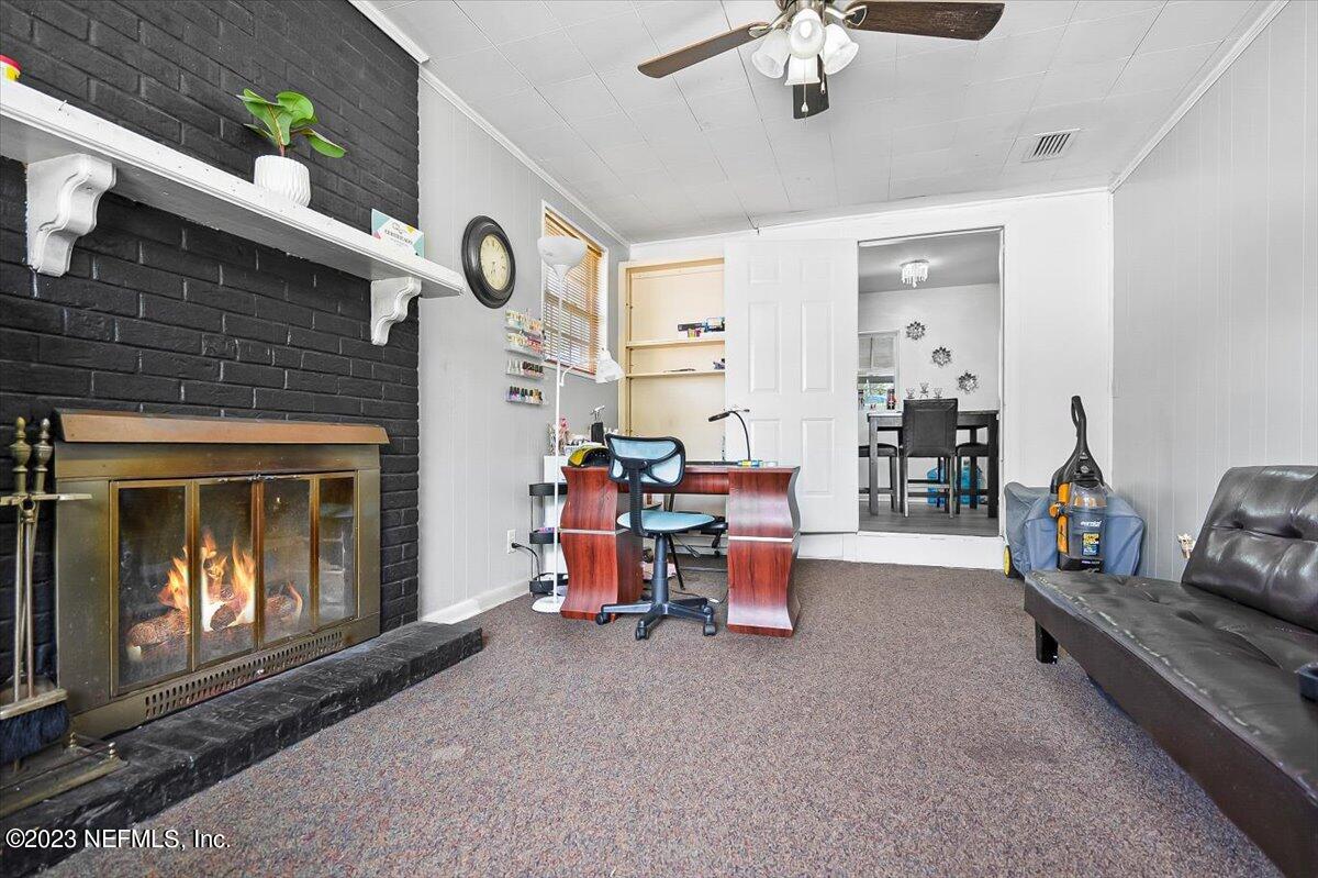 7240 Adele Court Jacksonville, FL 32277 - Photo 13 of 27 a living room with furniture and a fireplace
