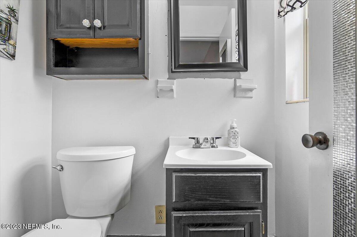 7240 Adele Court Jacksonville, FL 32277 - Photo 16 of 27 a bathroom with a toilet a sink and mirror